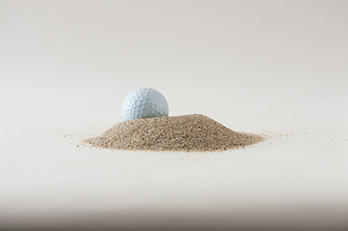 product image of golf ball in sand sample